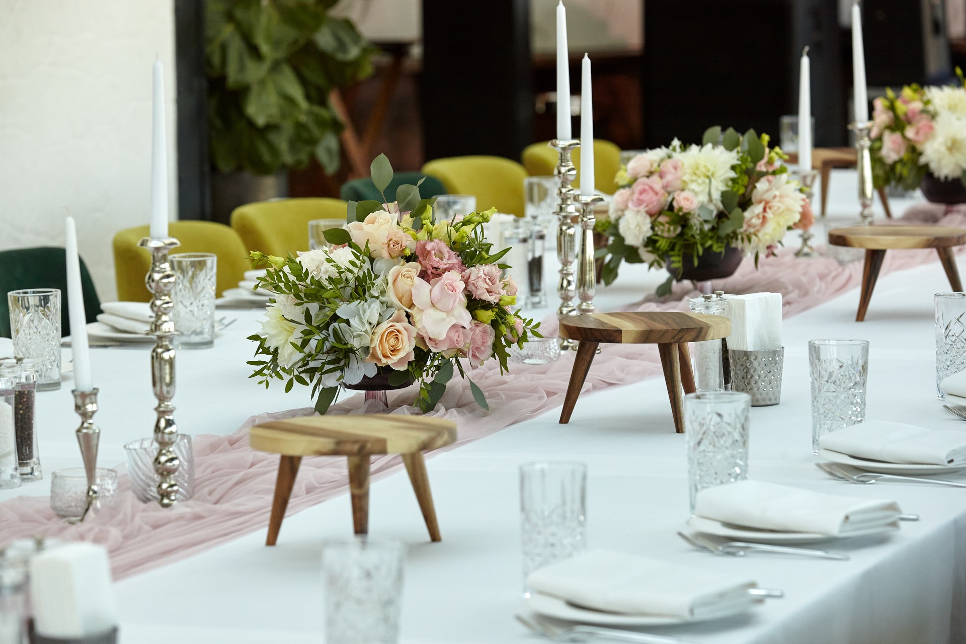 Banquet table for a wedding or holiday dinner decorated with flowers close-up.